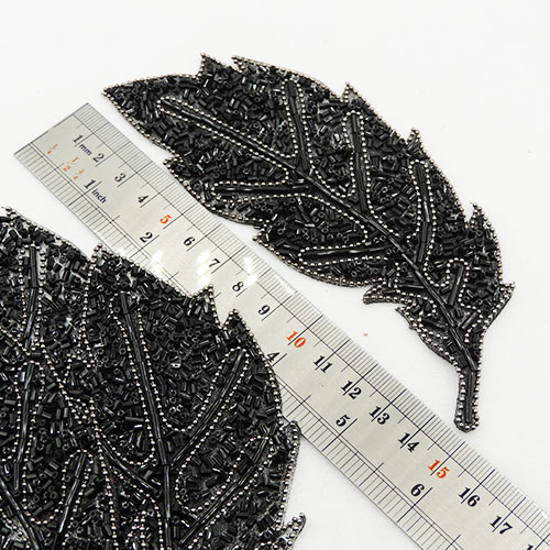 تصویر پنل لباس مجلسی لواشکی پر طاووس مشکی